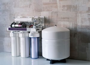 Water filter with three canisters on a countertop