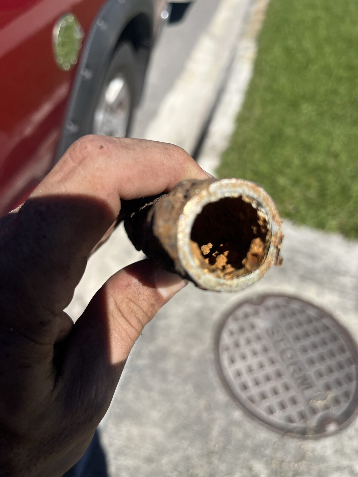 Corroded galvanized pipe with interior buildup removed during a water treatment install