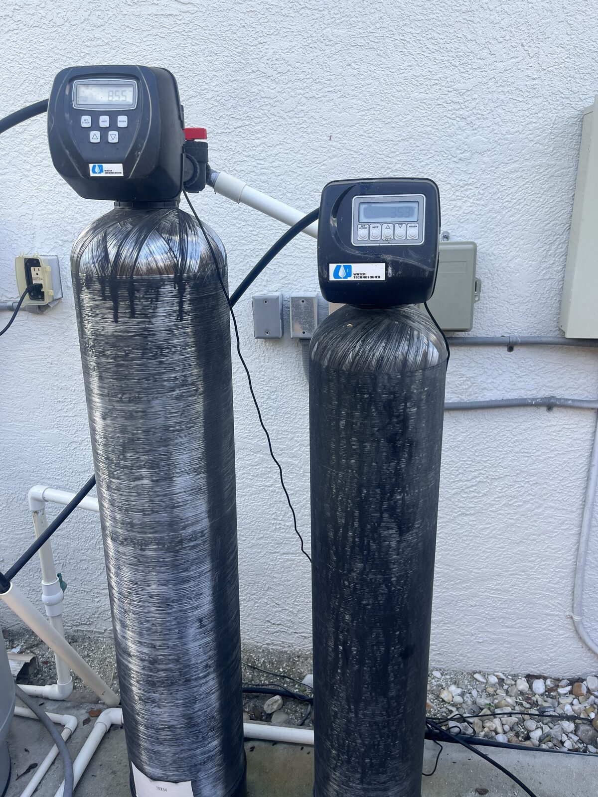 Old non-working two-tank water treatment system before replacement