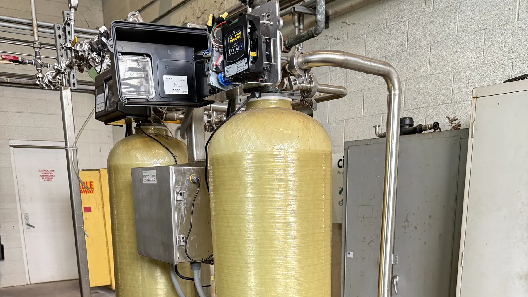 Twin-tank commercial water softener and brine tank installed by Hydrology Water Solutions