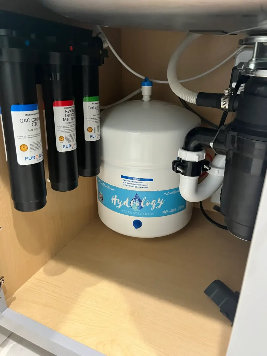 Puronics Micromax reverse osmosis system installed under a kitchen sink