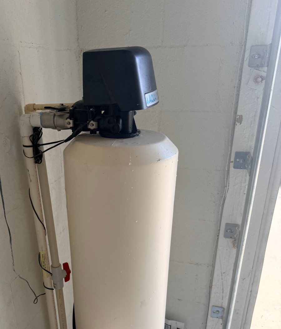 Old water softener in a Lakewood Ranch garage that stopped drawing brine, before Hydrology replaced it
