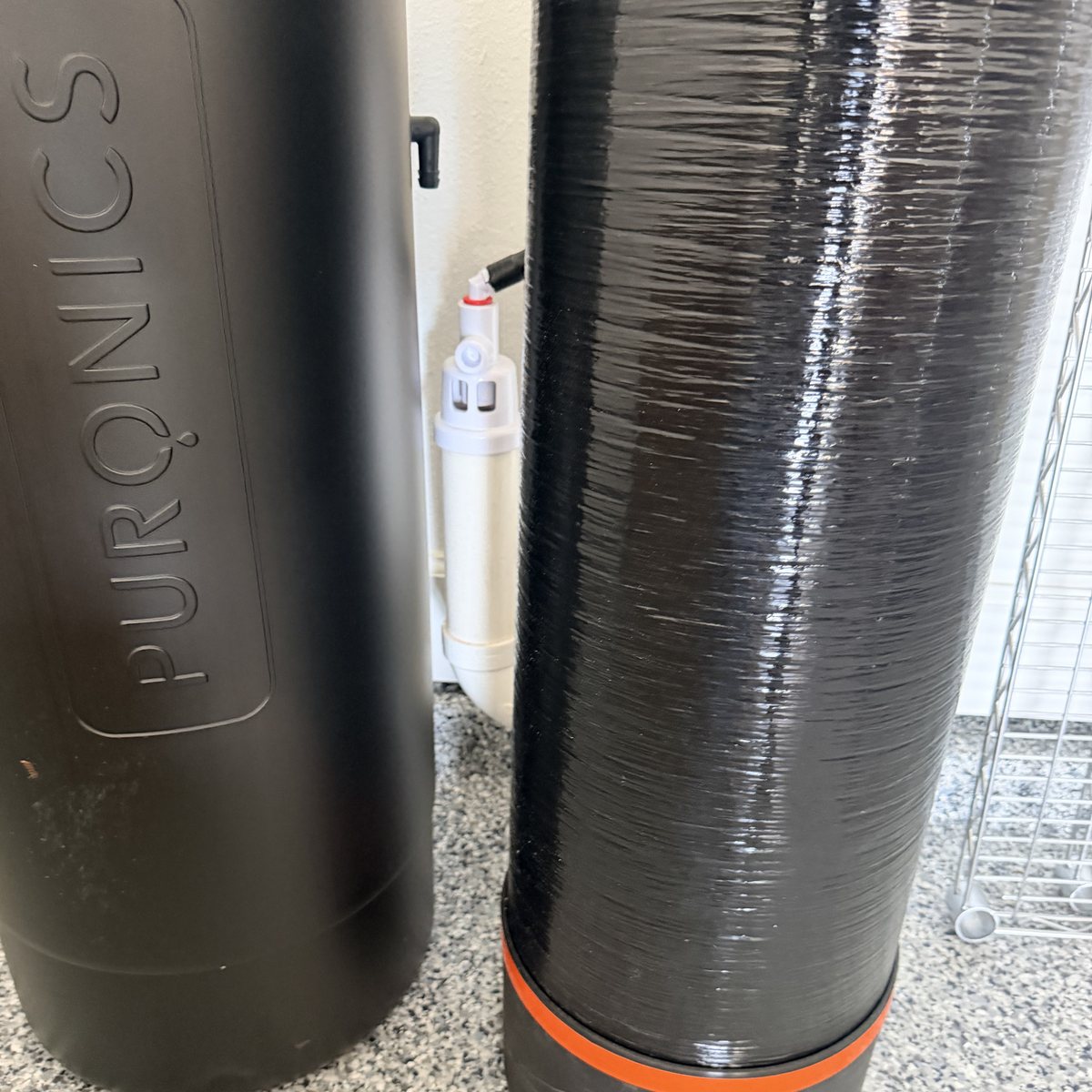 Air gap fitting installed between two Puronics tanks to keep drain water from back-siphoning into treated water