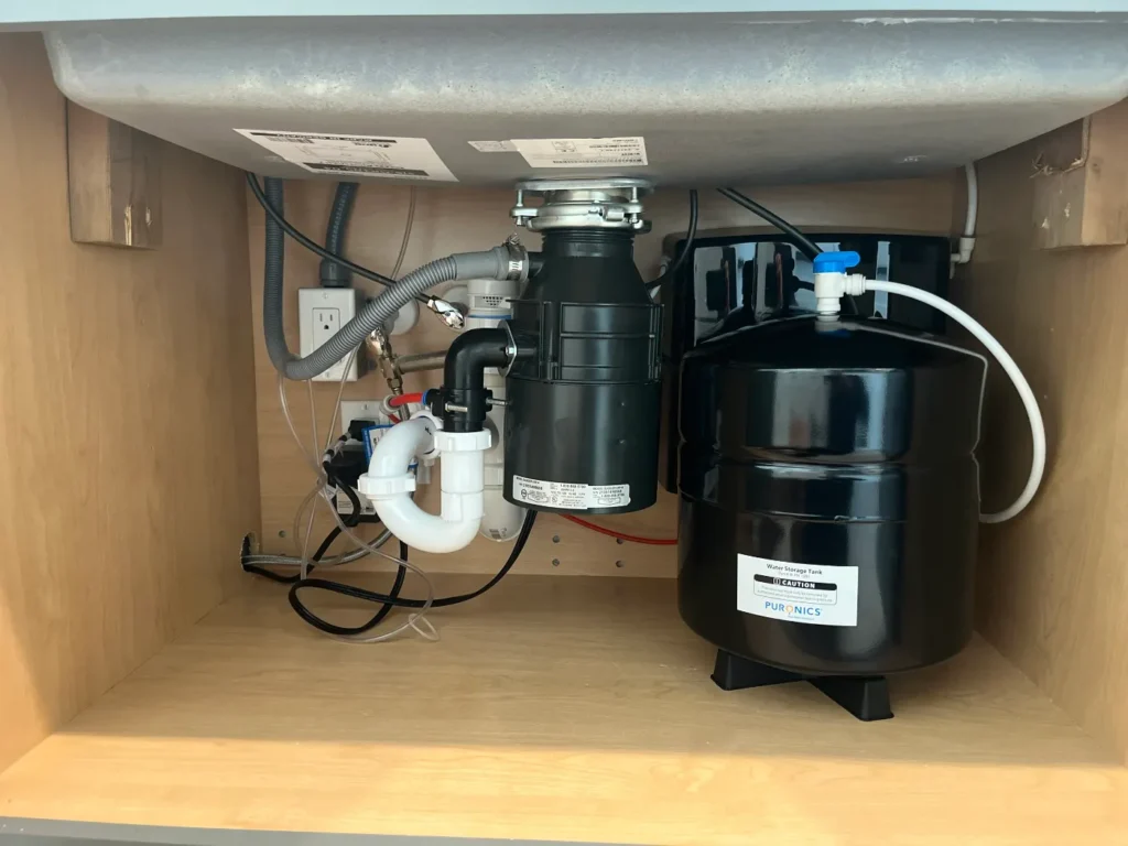 Puronics reverse osmosis storage tank installed under a kitchen sink by Hydrology Water Solutions
