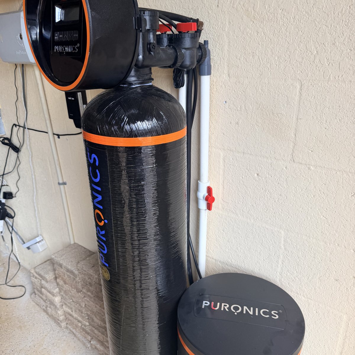 Puronics whole-home water softener and brine tank installed in a Lakewood Ranch garage