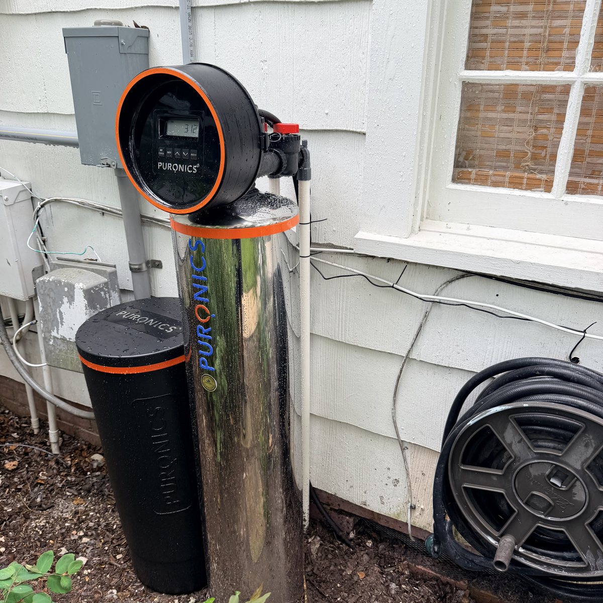 Puronics stainless whole-home water softener installed outdoors at a Parrish home