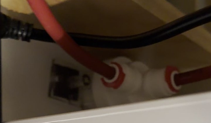 Leak detector installed behind a tankless reverse osmosis unit under the sink