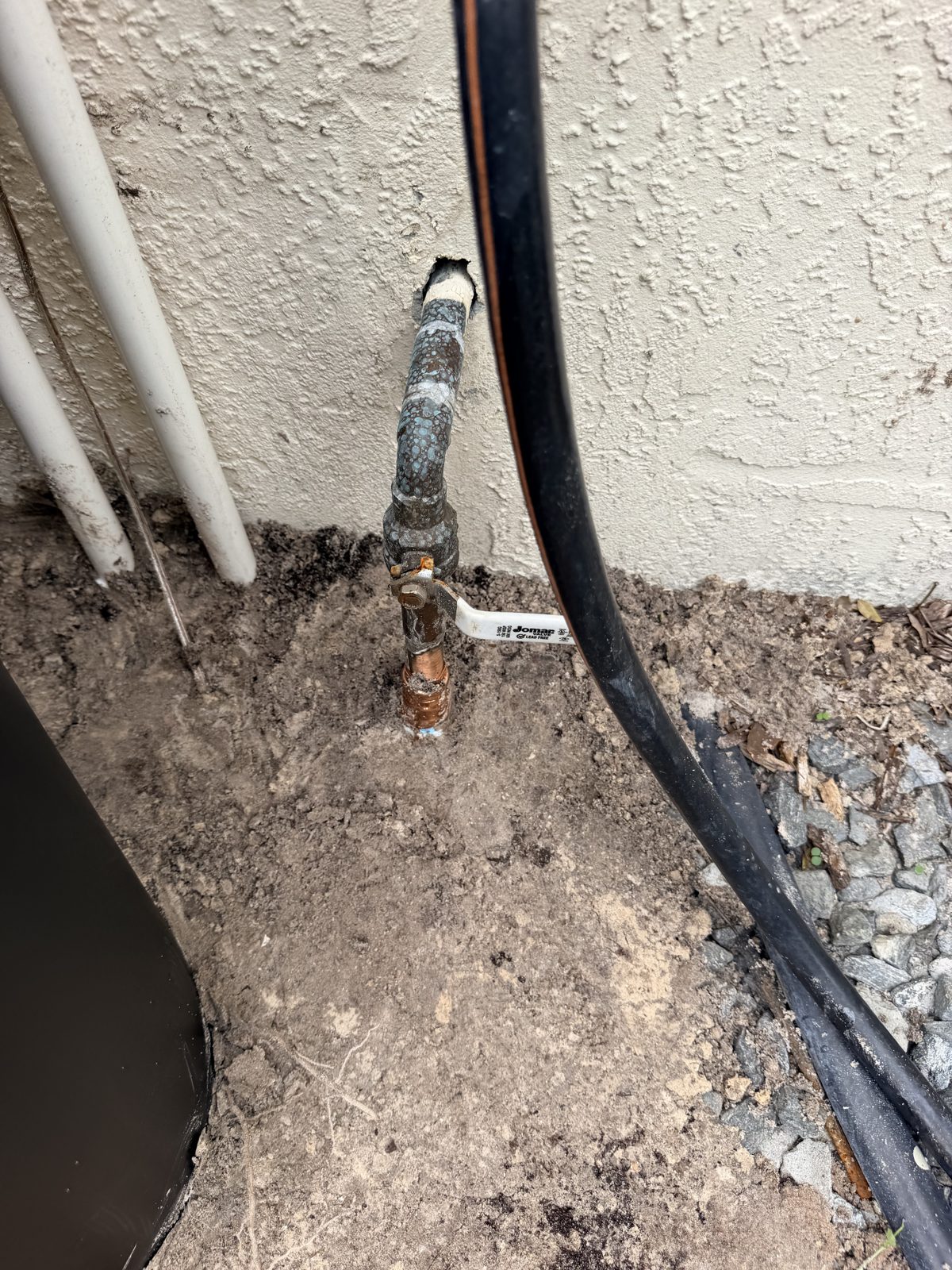 Main water line and shutoff valve where a whole-home water softener ties in