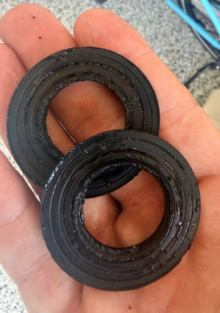 Worn seals and spacers removed from a water softener valve during a repair