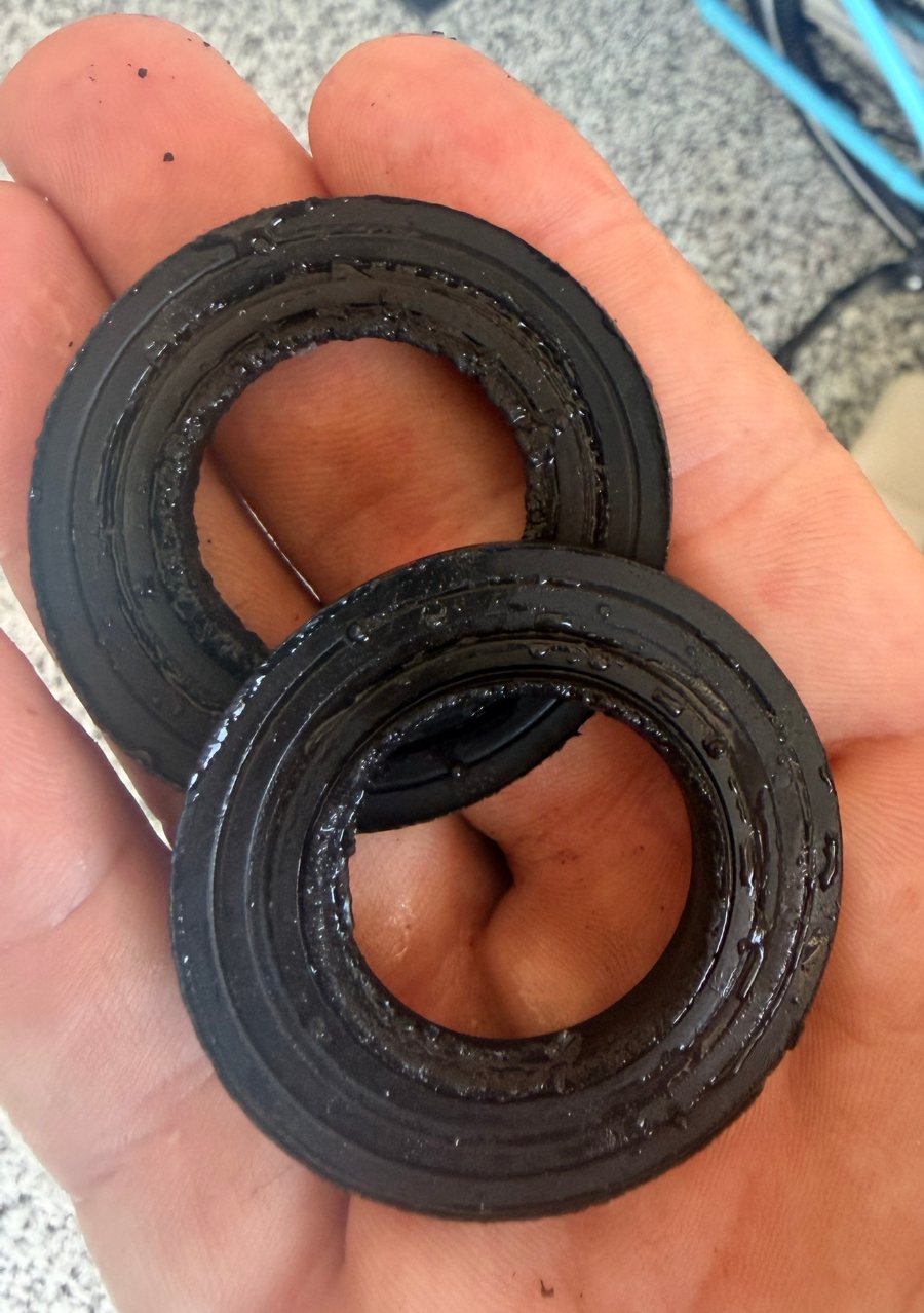Worn seals and spacers removed from the old softener valve during the rebuild