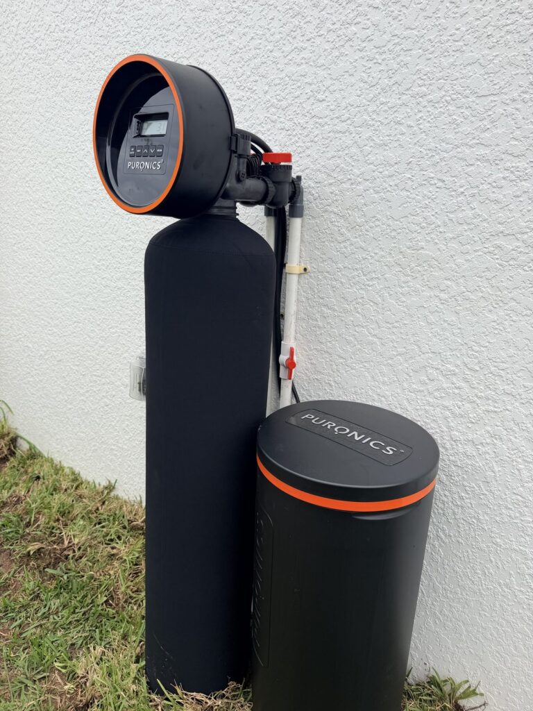 Puronics Defender whole-home water system and brine tank installed outside a home in Palmetto, Florida