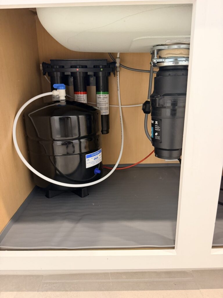 Puronics Micromax 7000 reverse osmosis system and storage tank under a kitchen sink in Parrish, Florida