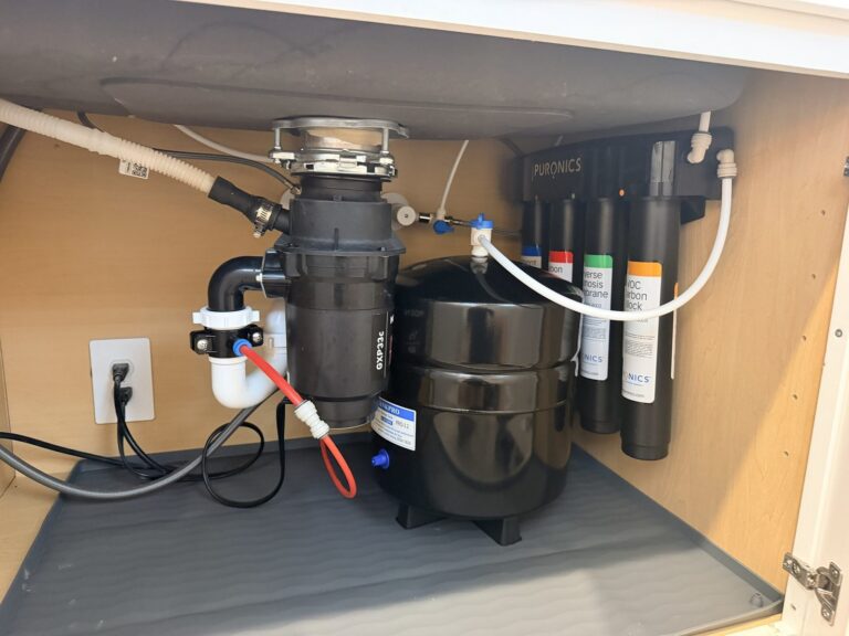 Puronics reverse osmosis system and storage tank installed under a kitchen sink in Palmetto, Florida